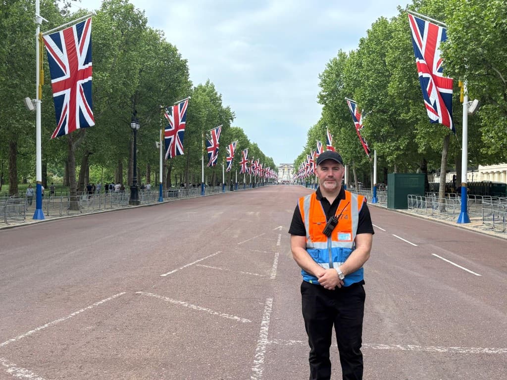 A K1 steward on The Mall in London, with Union Jacks lining the road